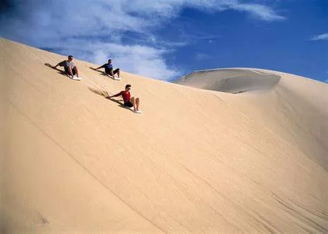 Sandboarding down a golden dune in Fayoum