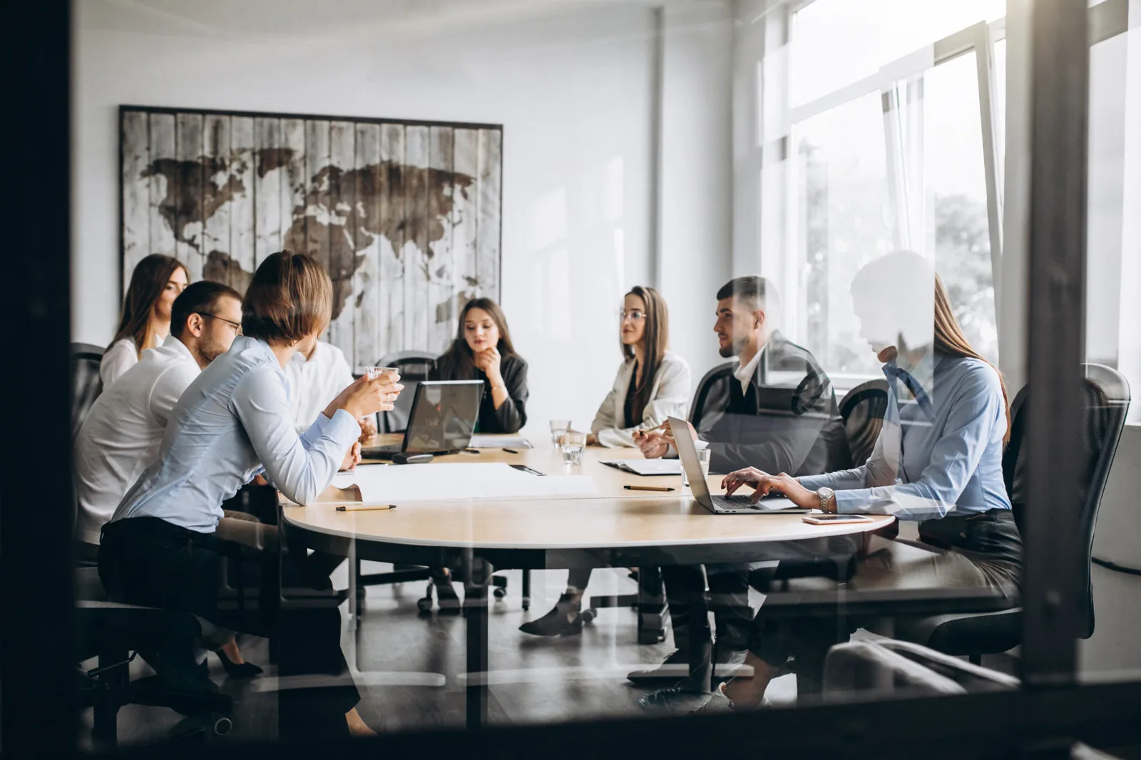 Colleagues in a meeting room around a round table